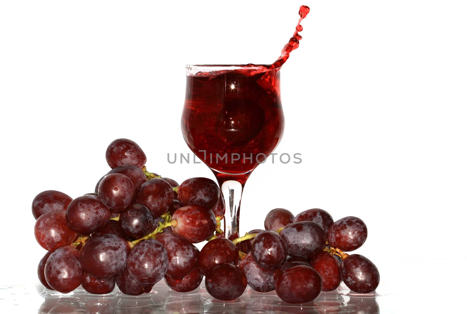 Goblet of red wine and grapes bunch isolated on white with clipping path
