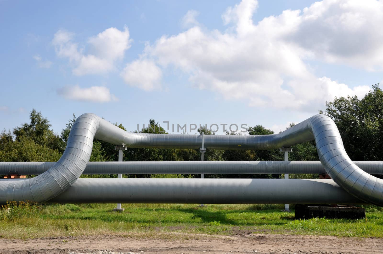 Bend of the pipeline on a background of clouds and the dark blue sky