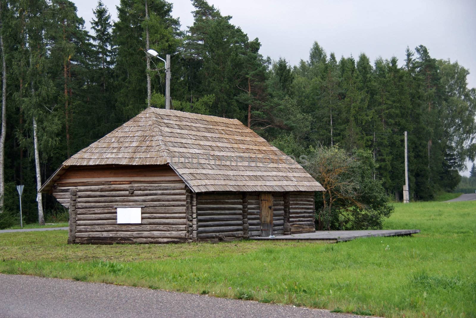 Barn of logs on the background of trees