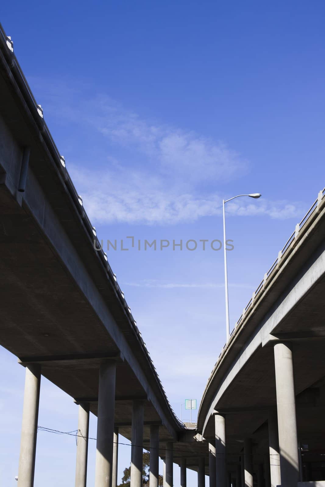 Contrasting Pillars of a Highway Overpass With a Bright Blue Sky