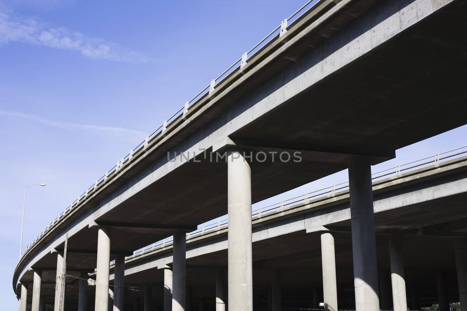 Contrasting Pillars of a Highway Overpass With a Bright Blue Sky