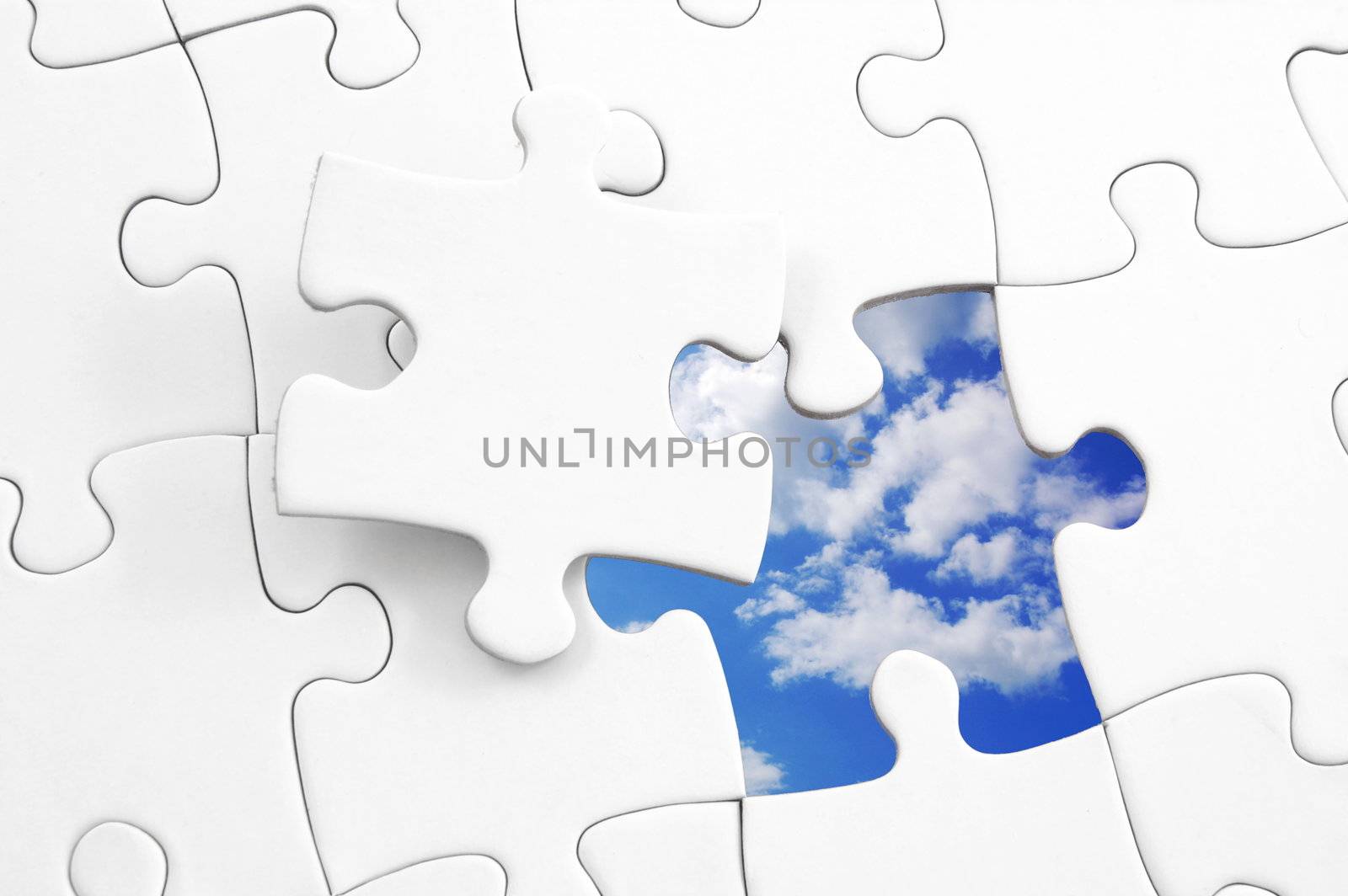 puzzle and blue cloudy sky showing freedom concept