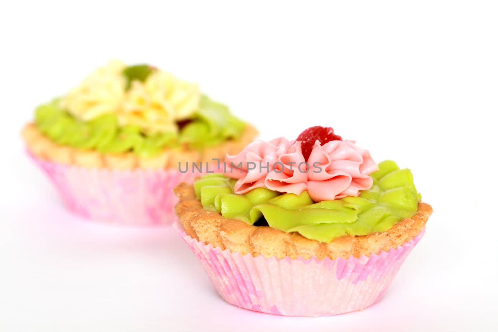 Two small colored tarts isolated on white background