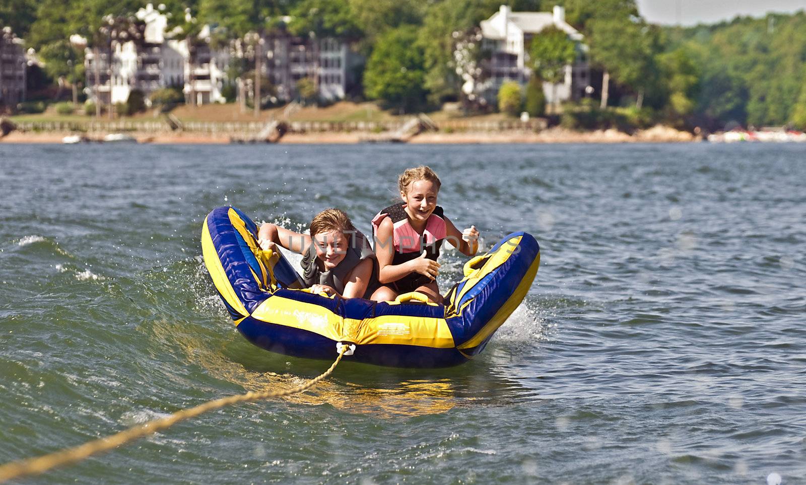 Children Tubing Behind a Boat by Noonie