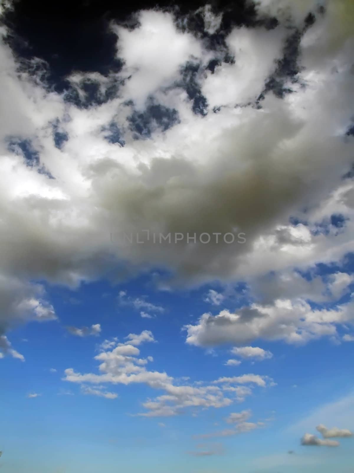 Clouds looming over the horizon with deep blue sky in background