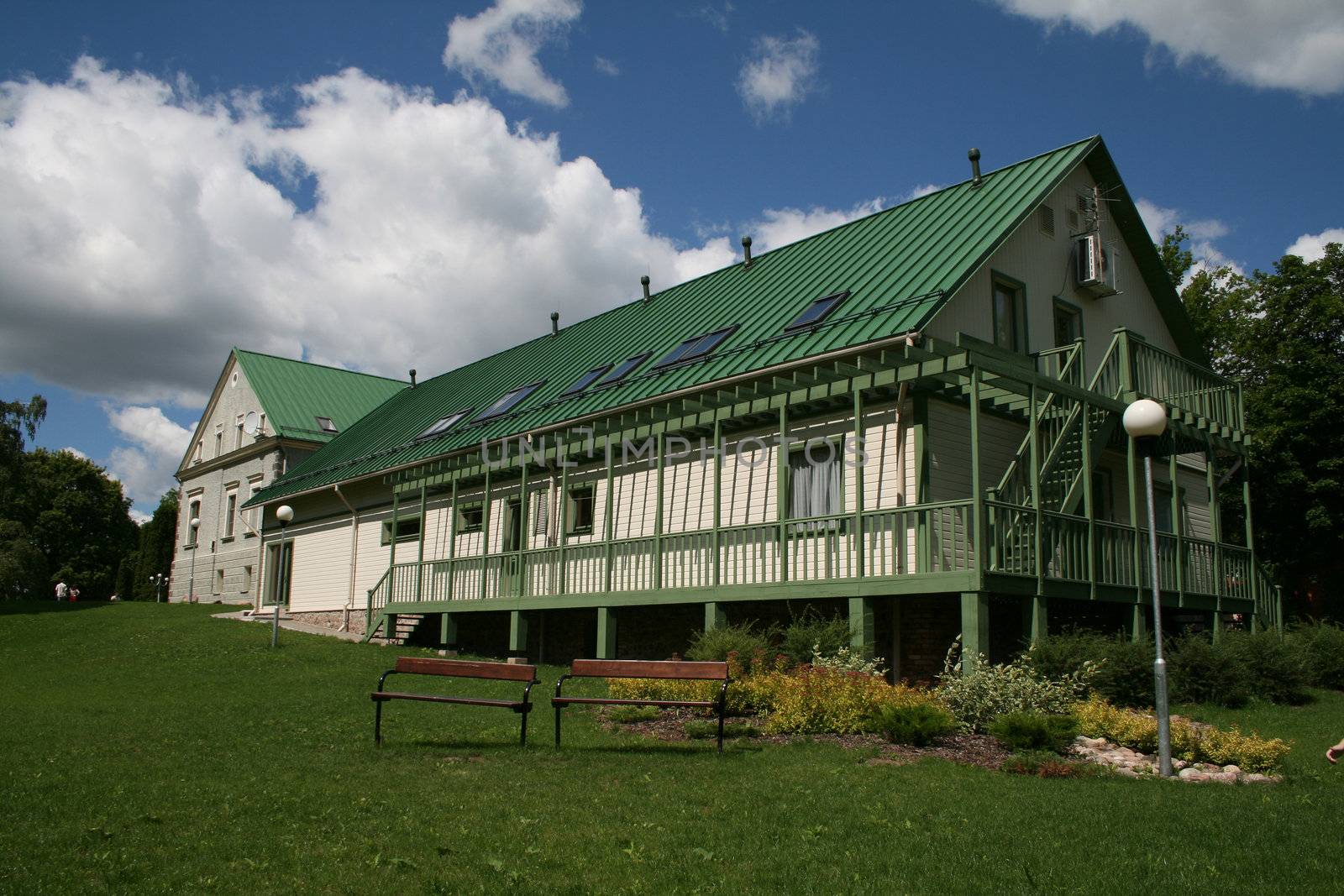 House in grassy foreground with flower