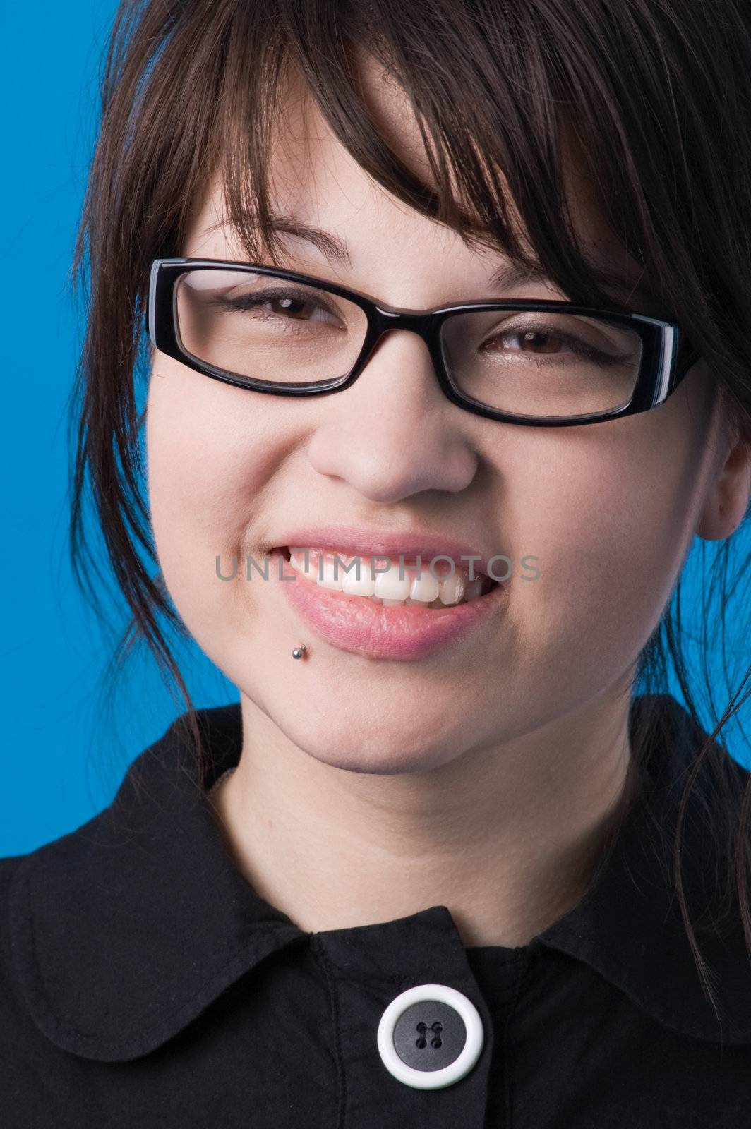 Girl in glasses, isolated on blue background.