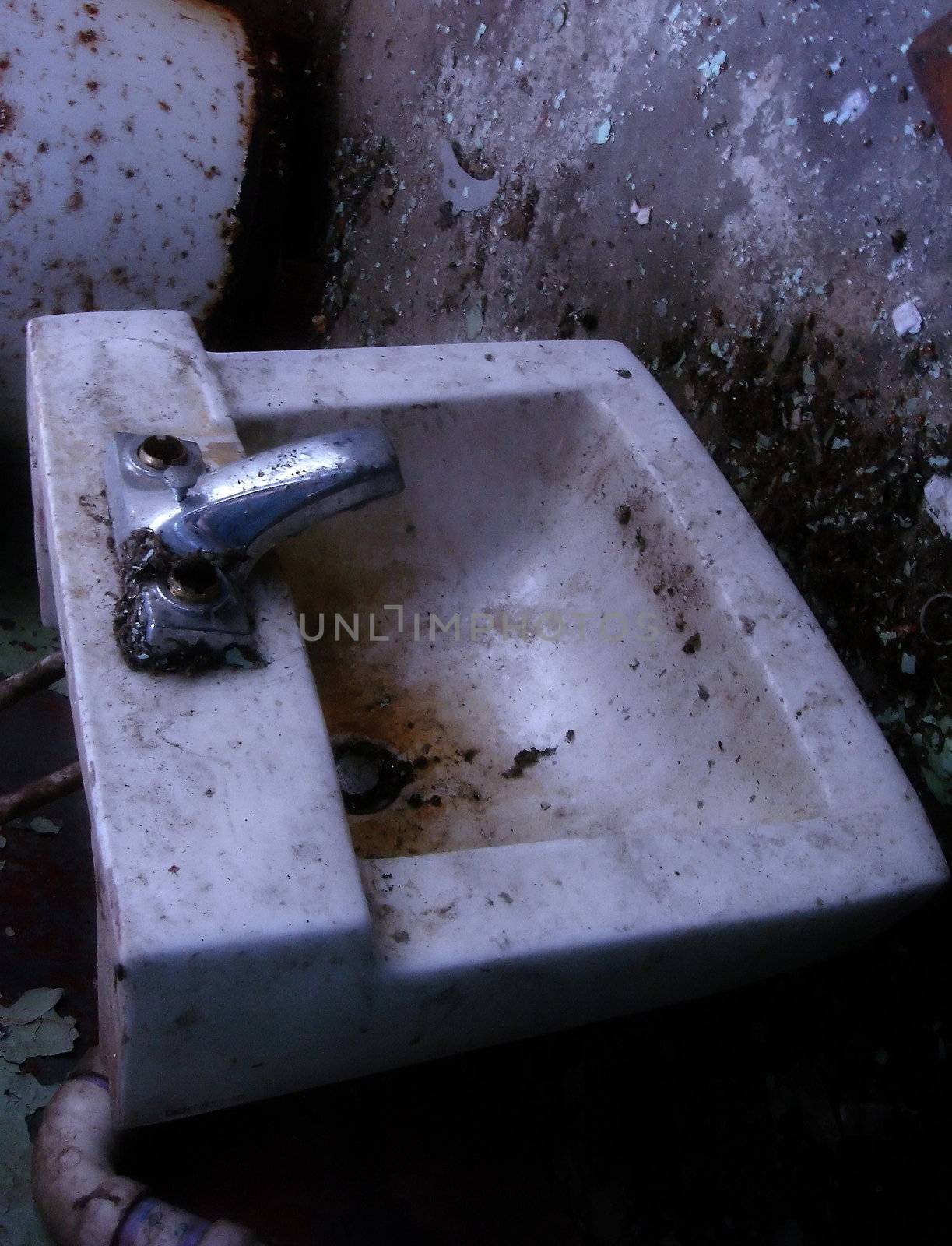 a filthy sink found in an abandoned building
