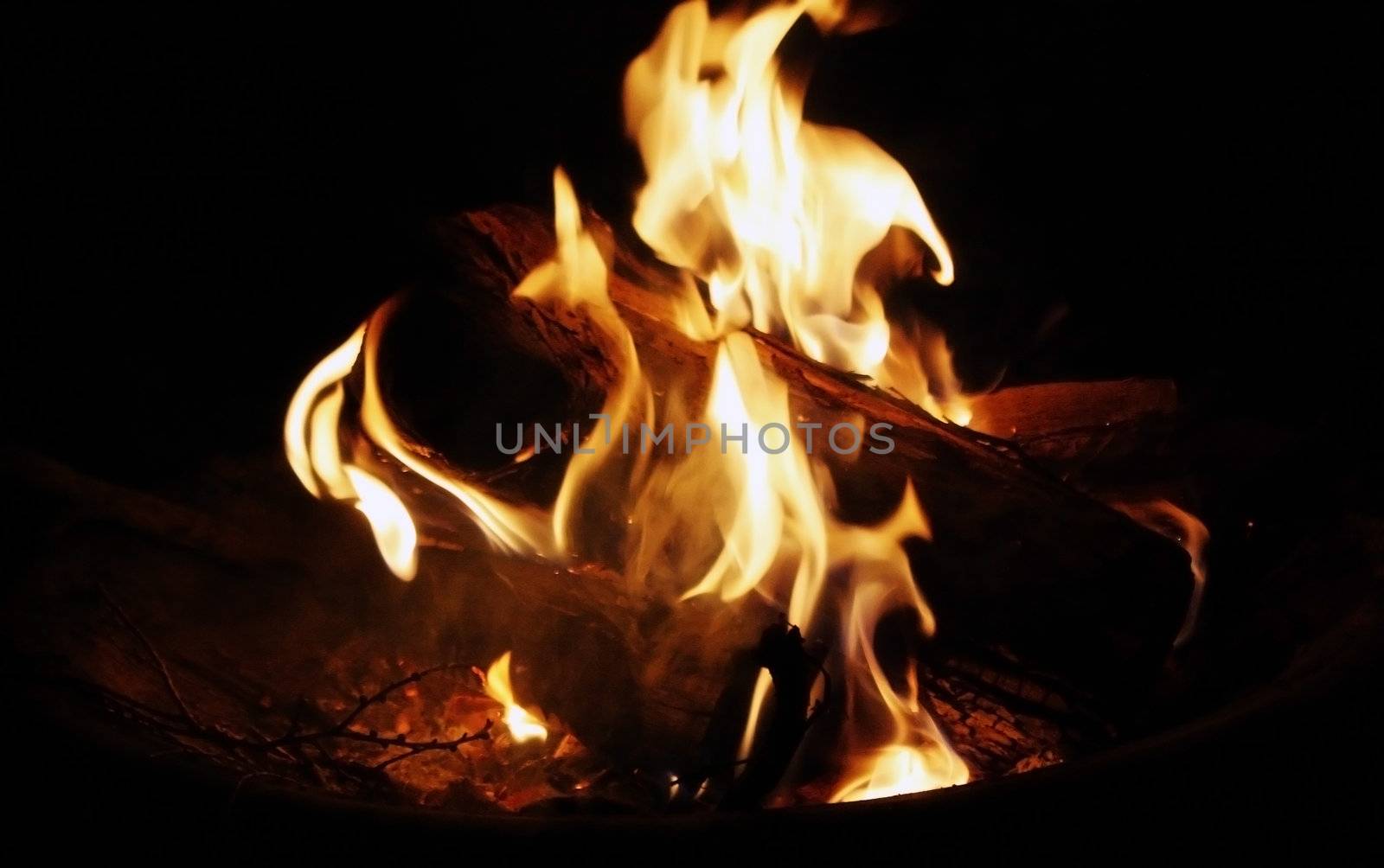 bonfire blazes on a cool summer night