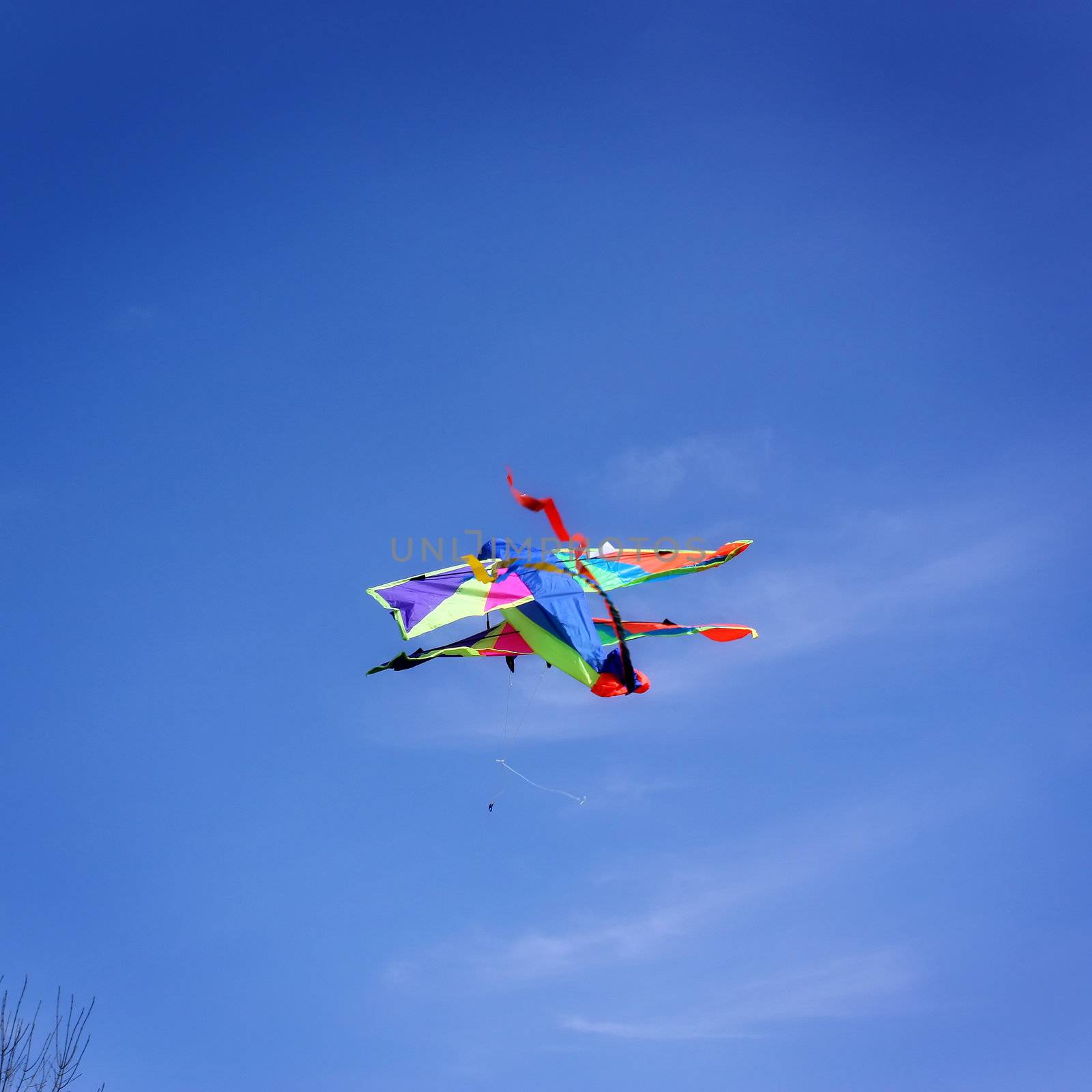 a colorful kite flies high in the sky