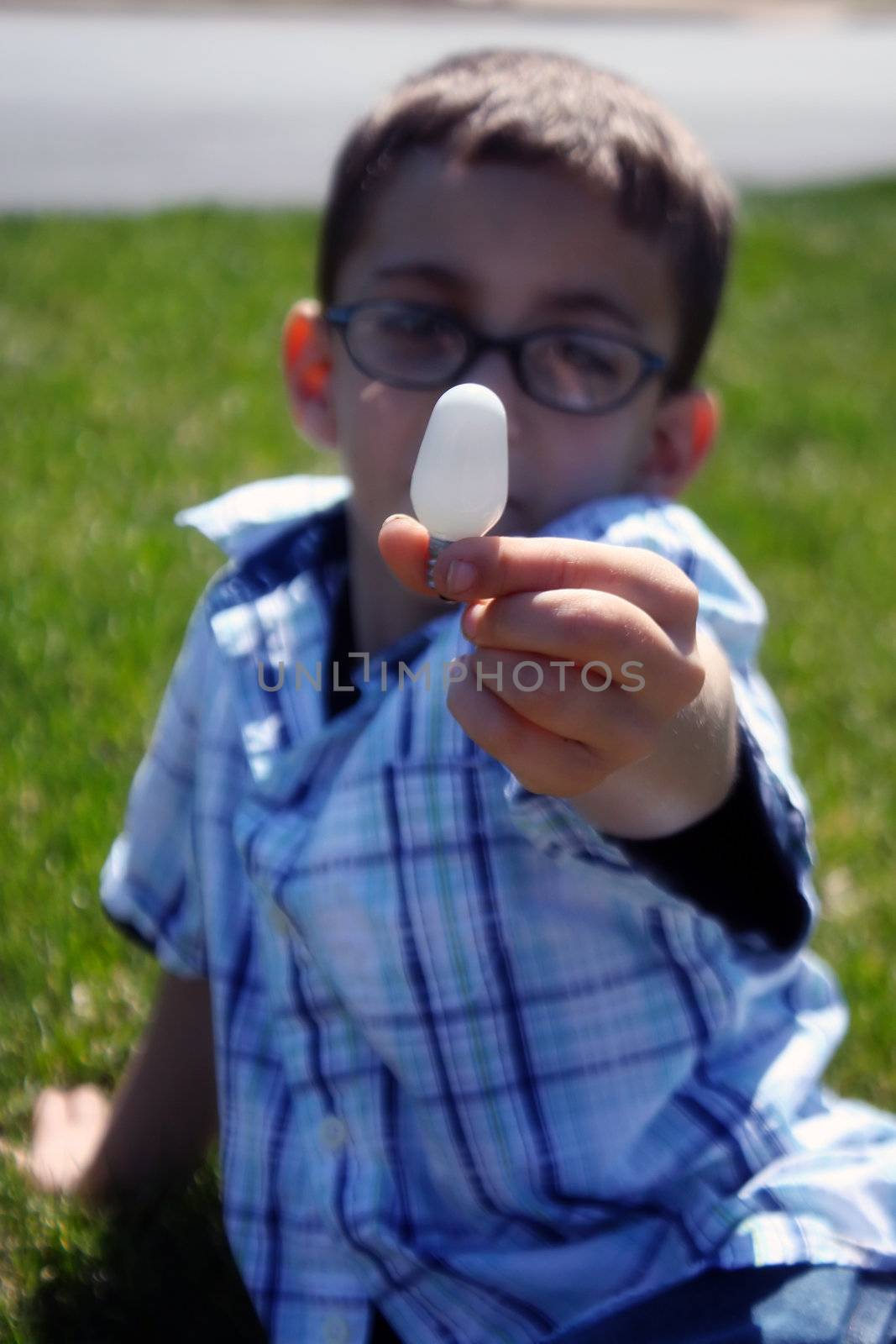 child holding light bulb by amandaols