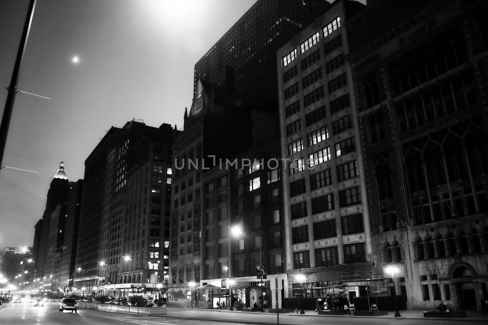 black and white photo of michigan avenue in chicago illinois at night