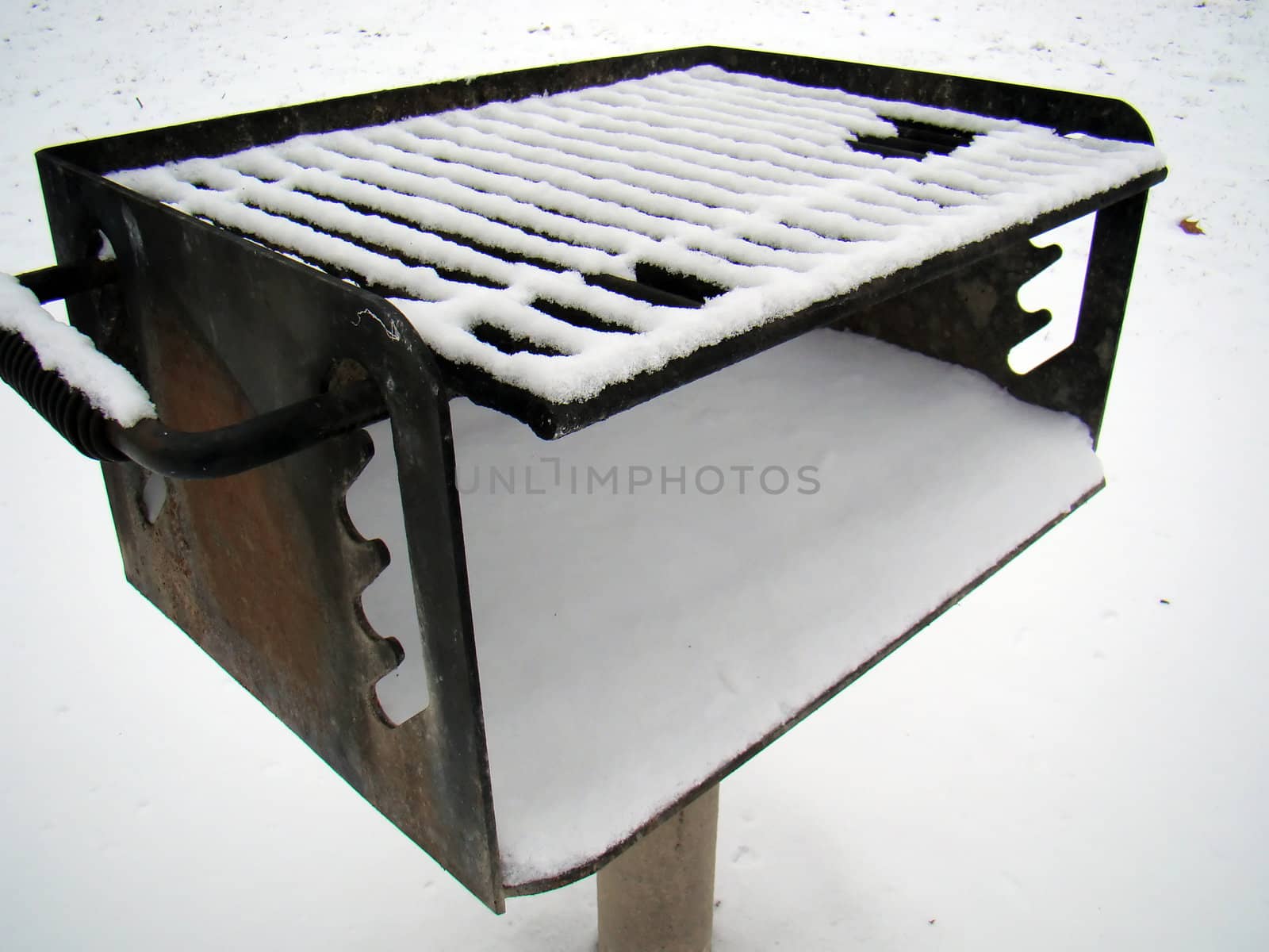 a forest preserve grill, covered with snow