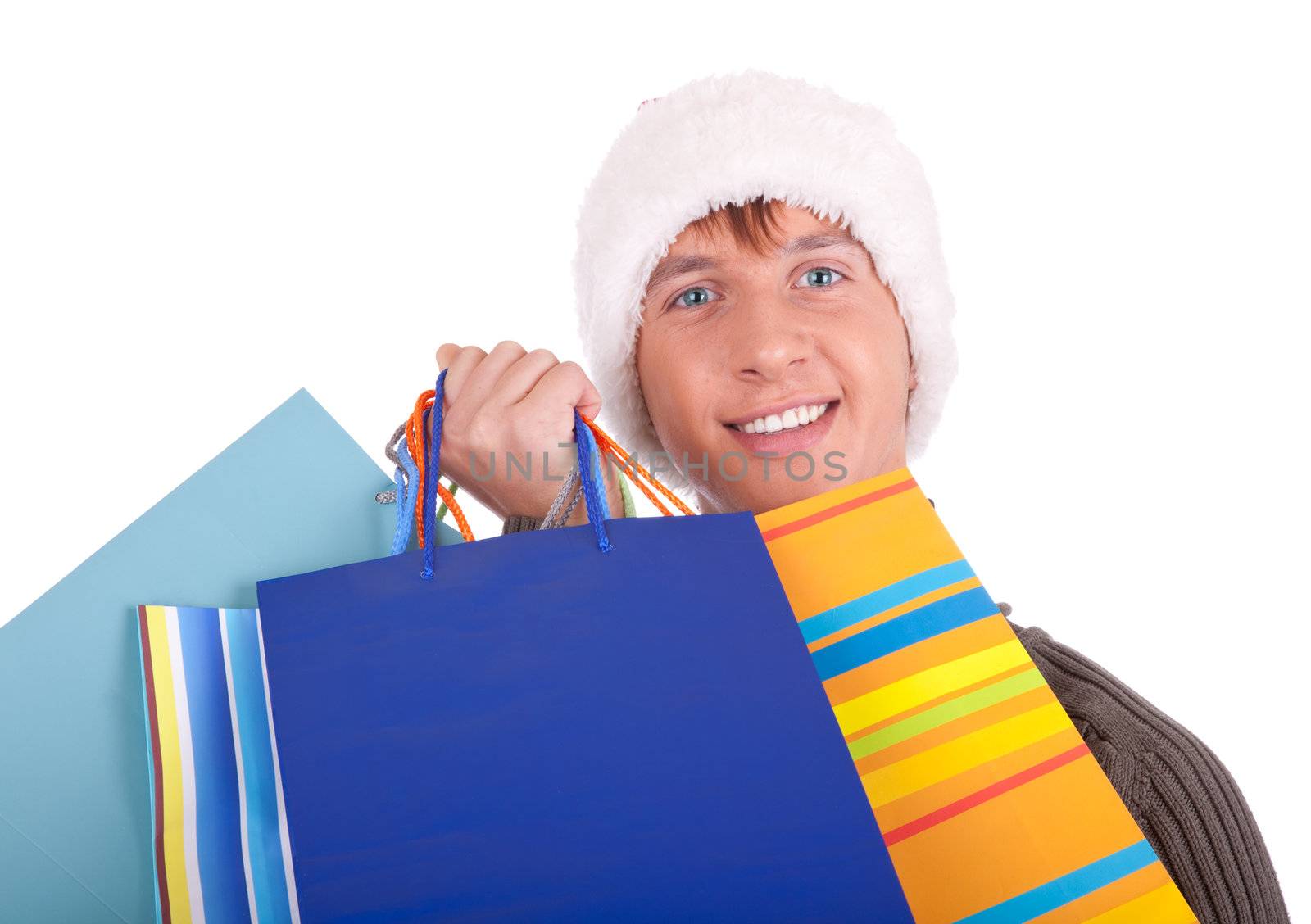 young man in a Santa Claus hat handing gift bags