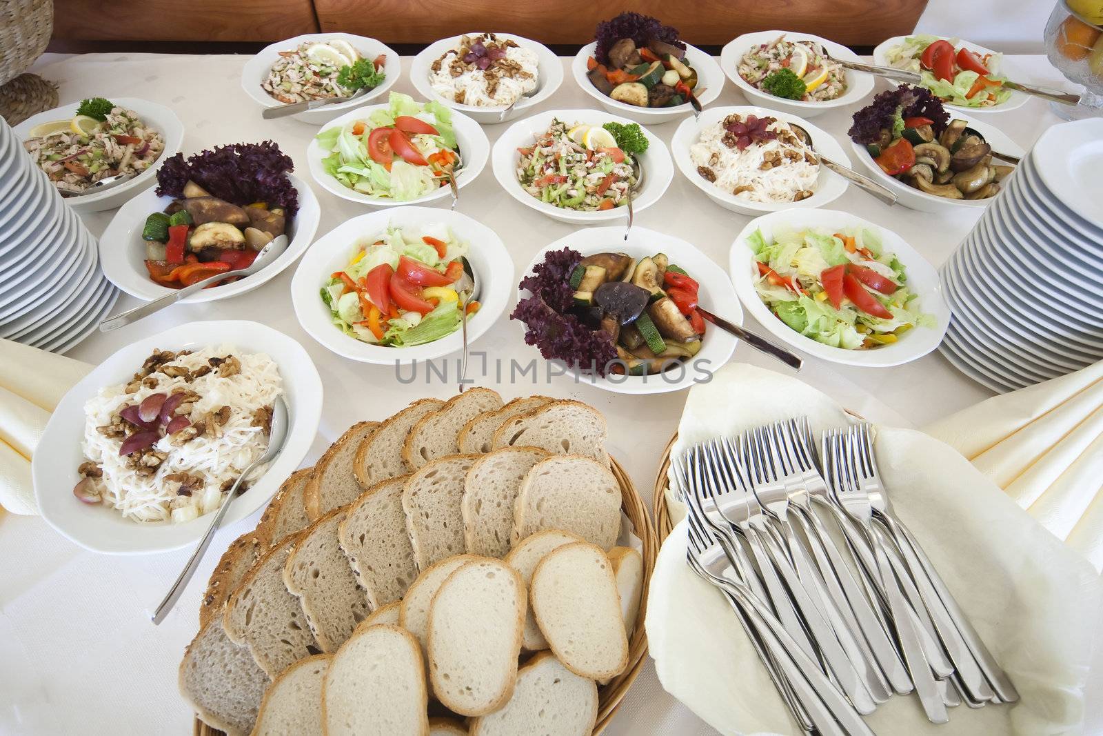 table full of salads, bread and fruits