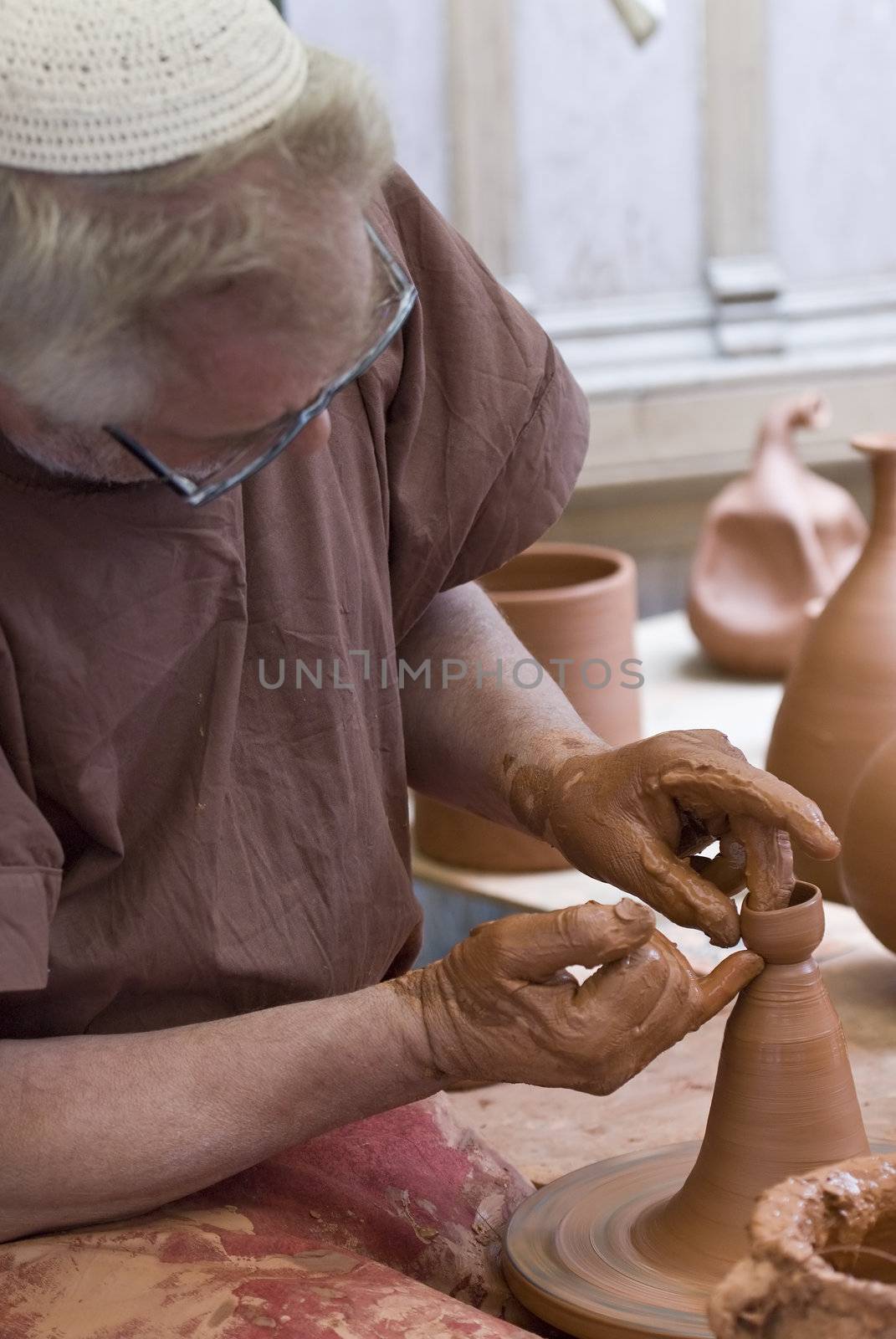 Potter in his workshop. by angelsimon