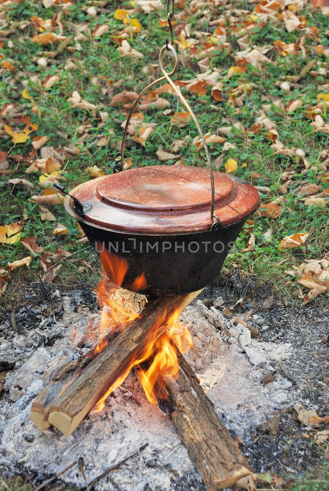 Traditional way of preparing food in a caldron hanging over fire. 