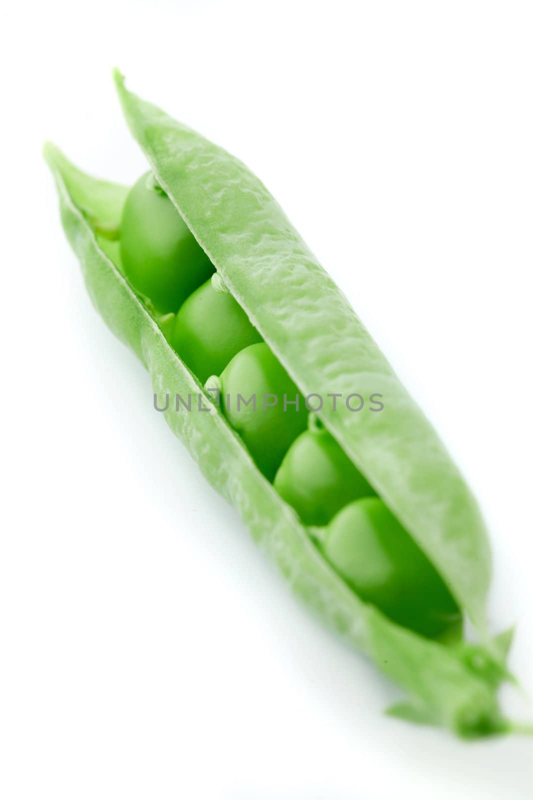 A pea pod revealing peas against white background