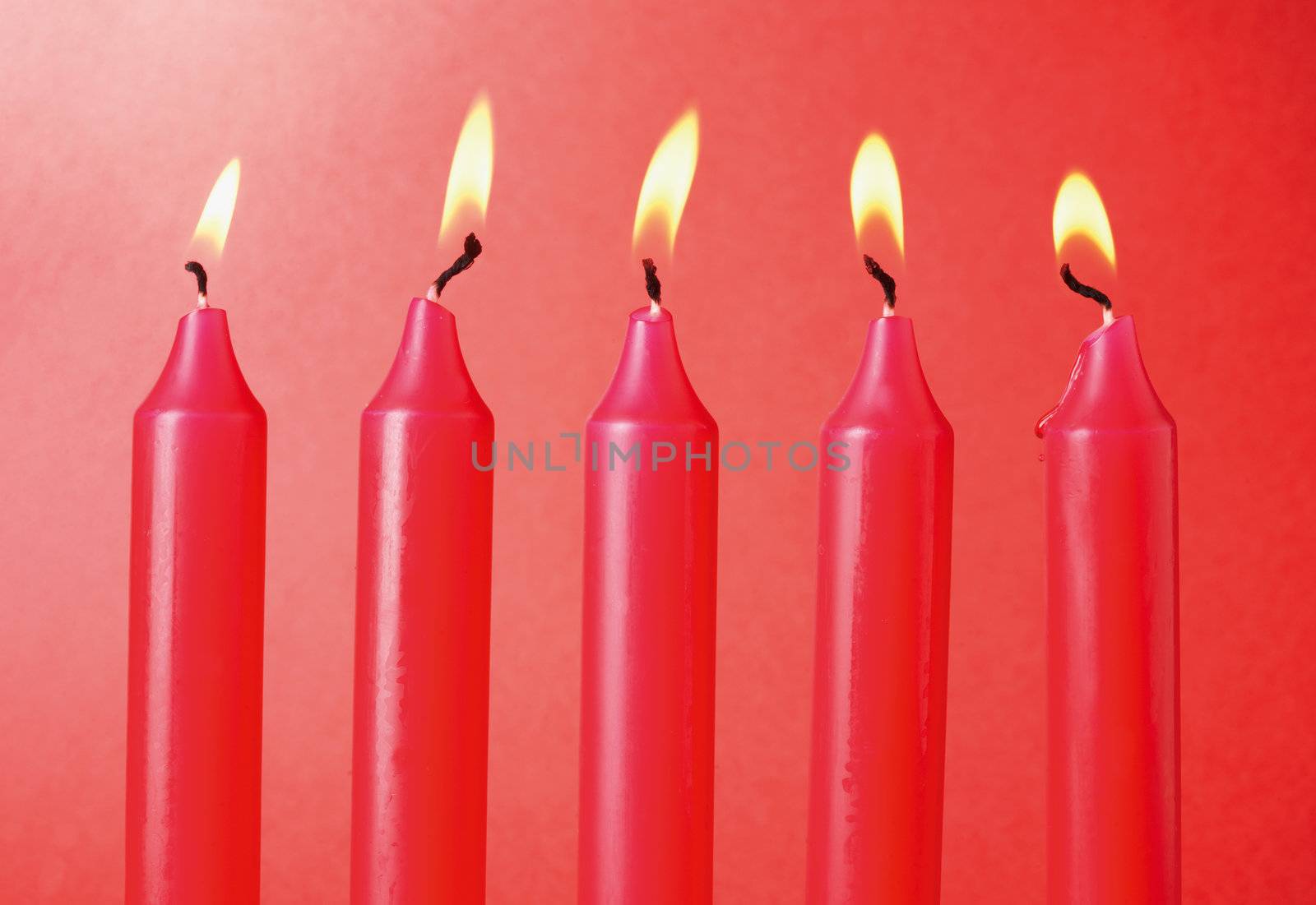 Five Red Candles on red  background.