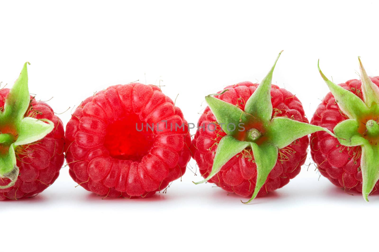  Row of raspberries with green leaves on white