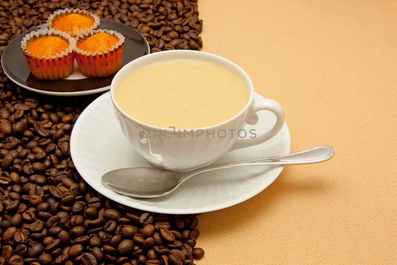 White cup of coffee and coffee beans