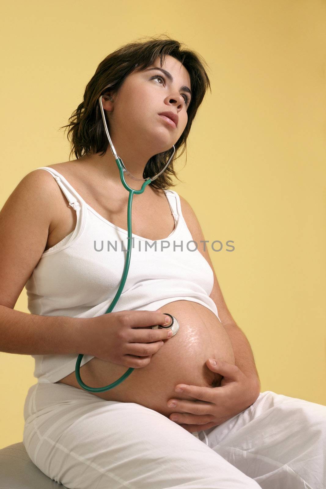 Pregnant mother listens to her unborn baby's heartbeat