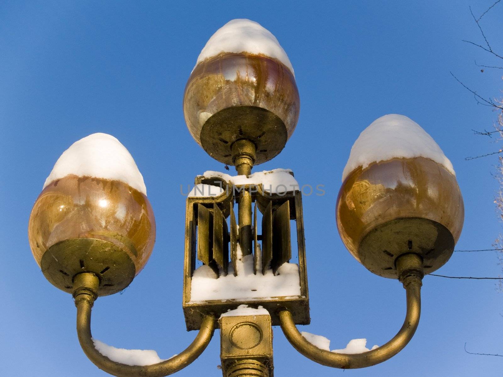 Street lamp shades covered with snow in Saratov