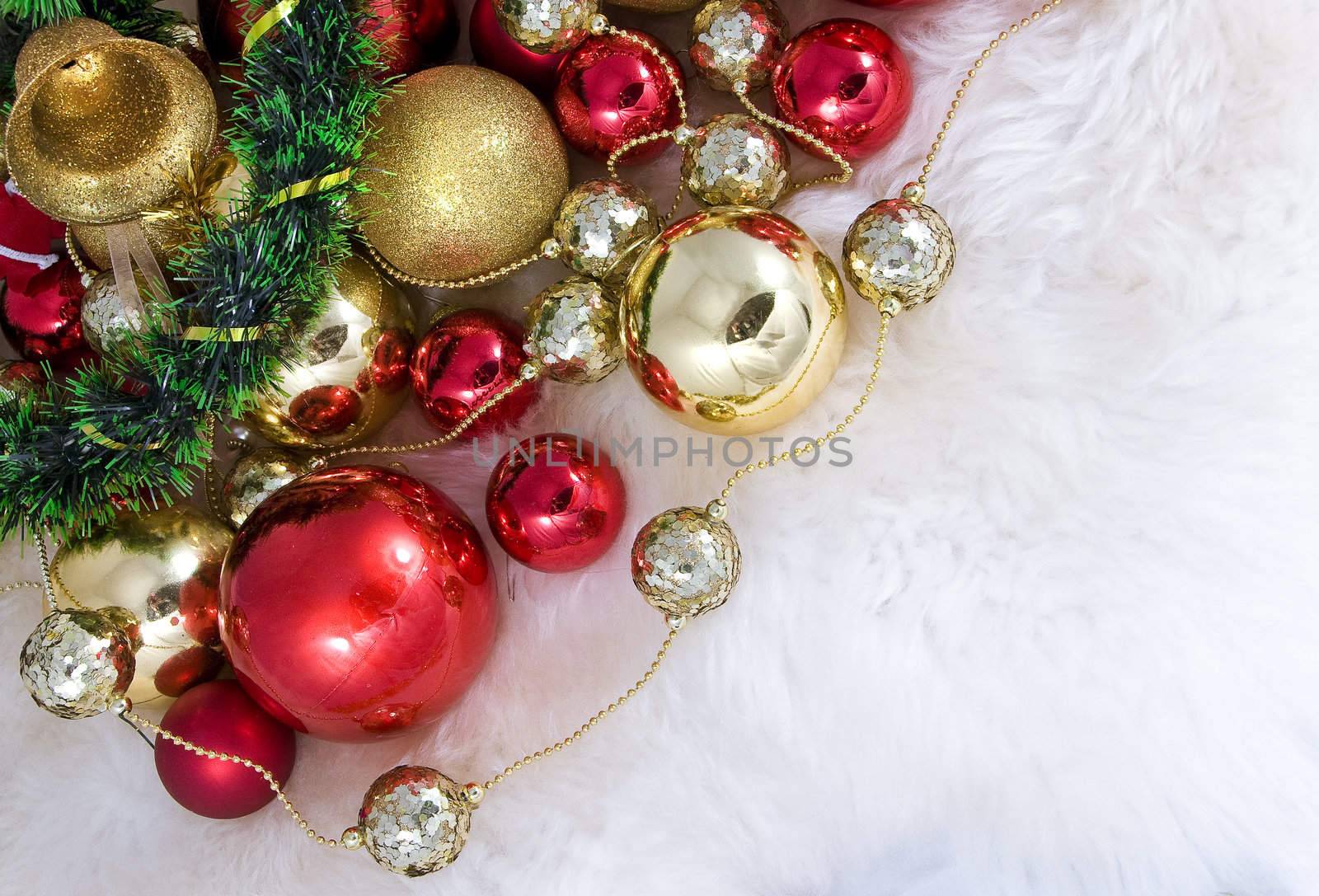 Elegant Christmas baubles with stars, angels and gold ribons on a slightly textured reflective surface
