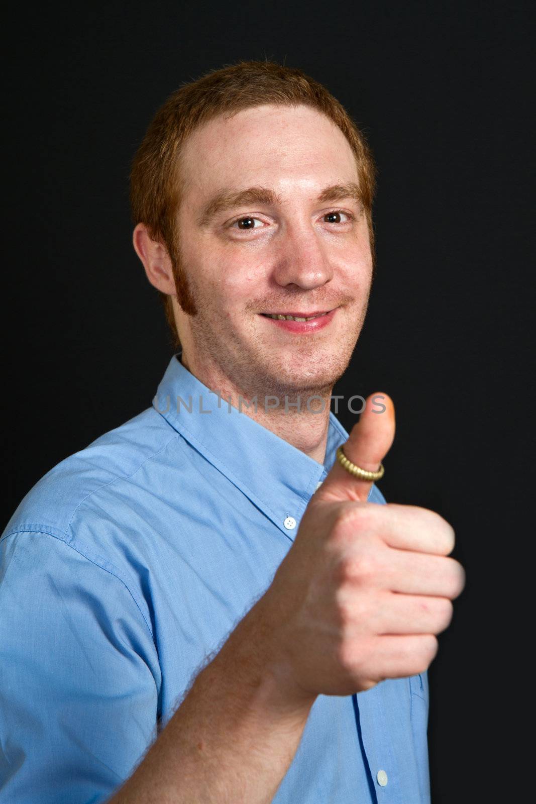 smiling young man with thumbs up 