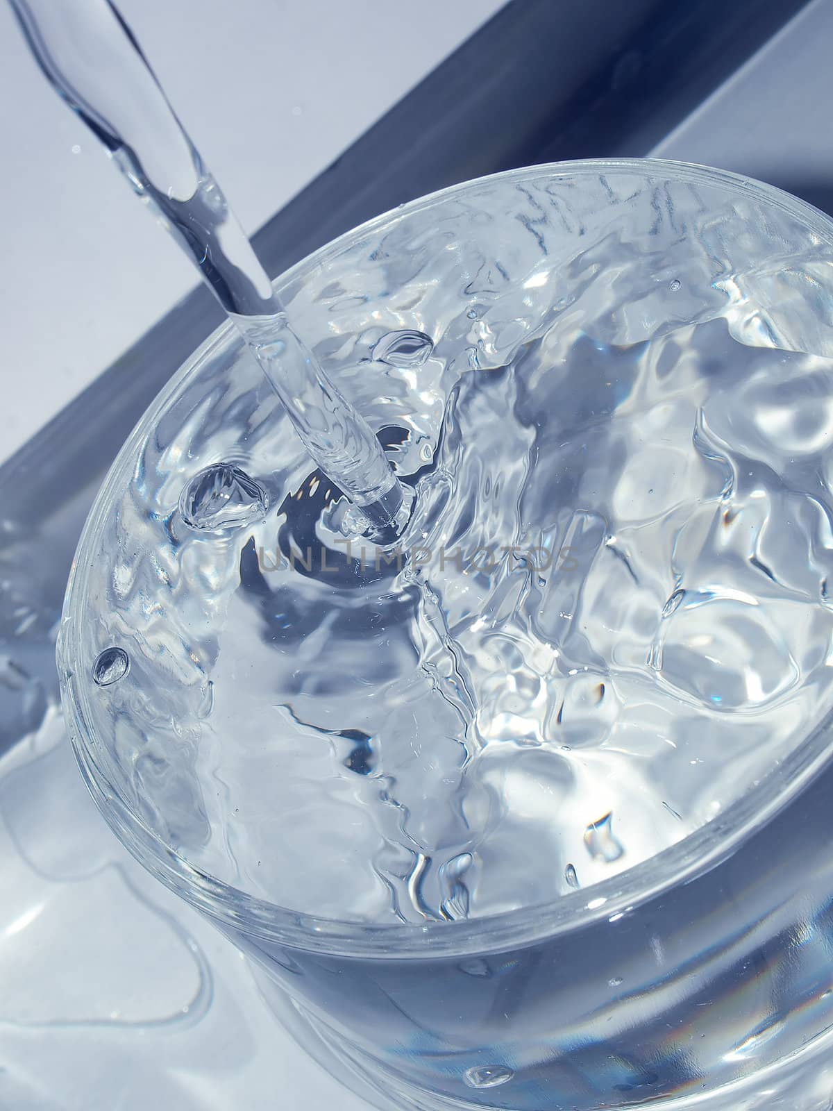 Close-up macro of water flow in a glass