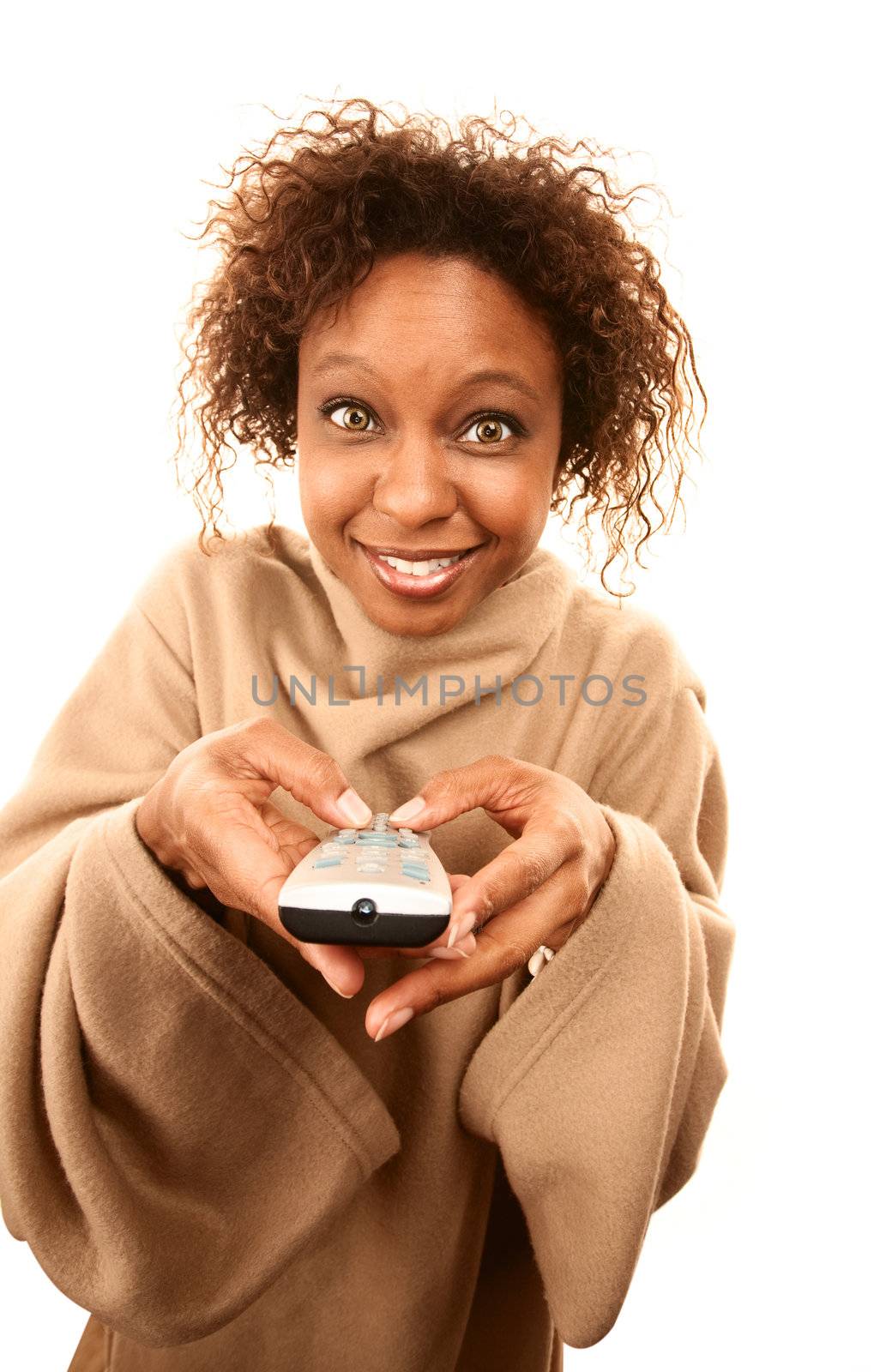 Pretty African American woman with remote control wearing blanket