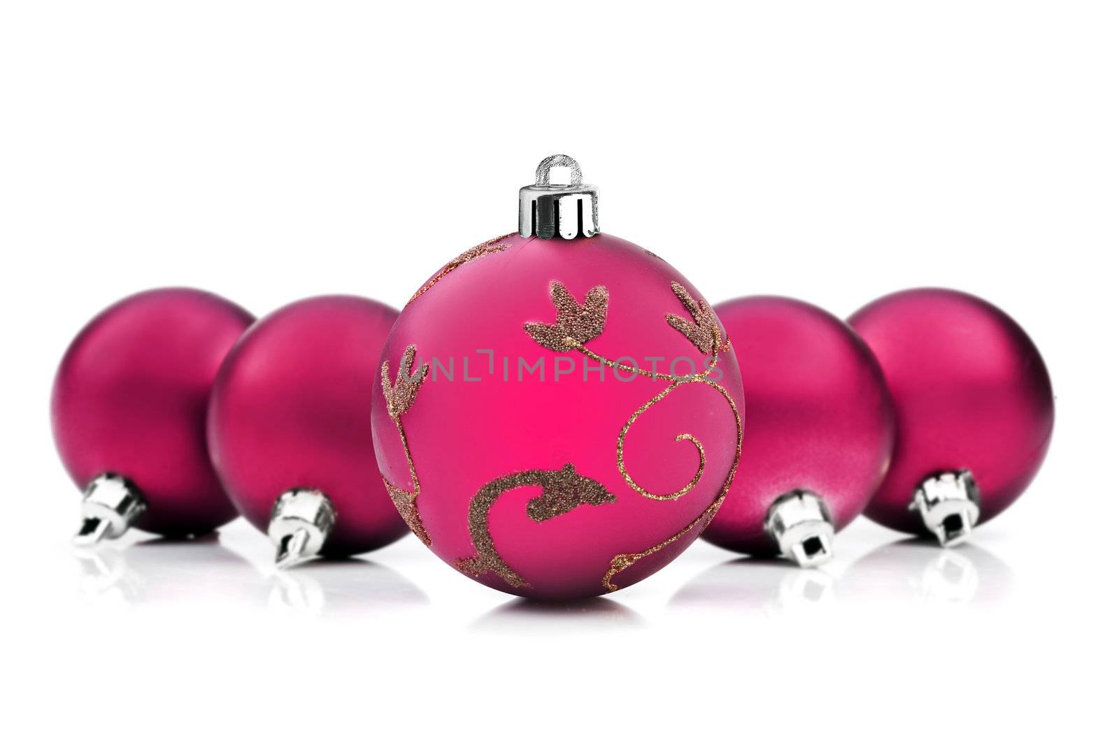 Pink christmas baubles on white background with space for text