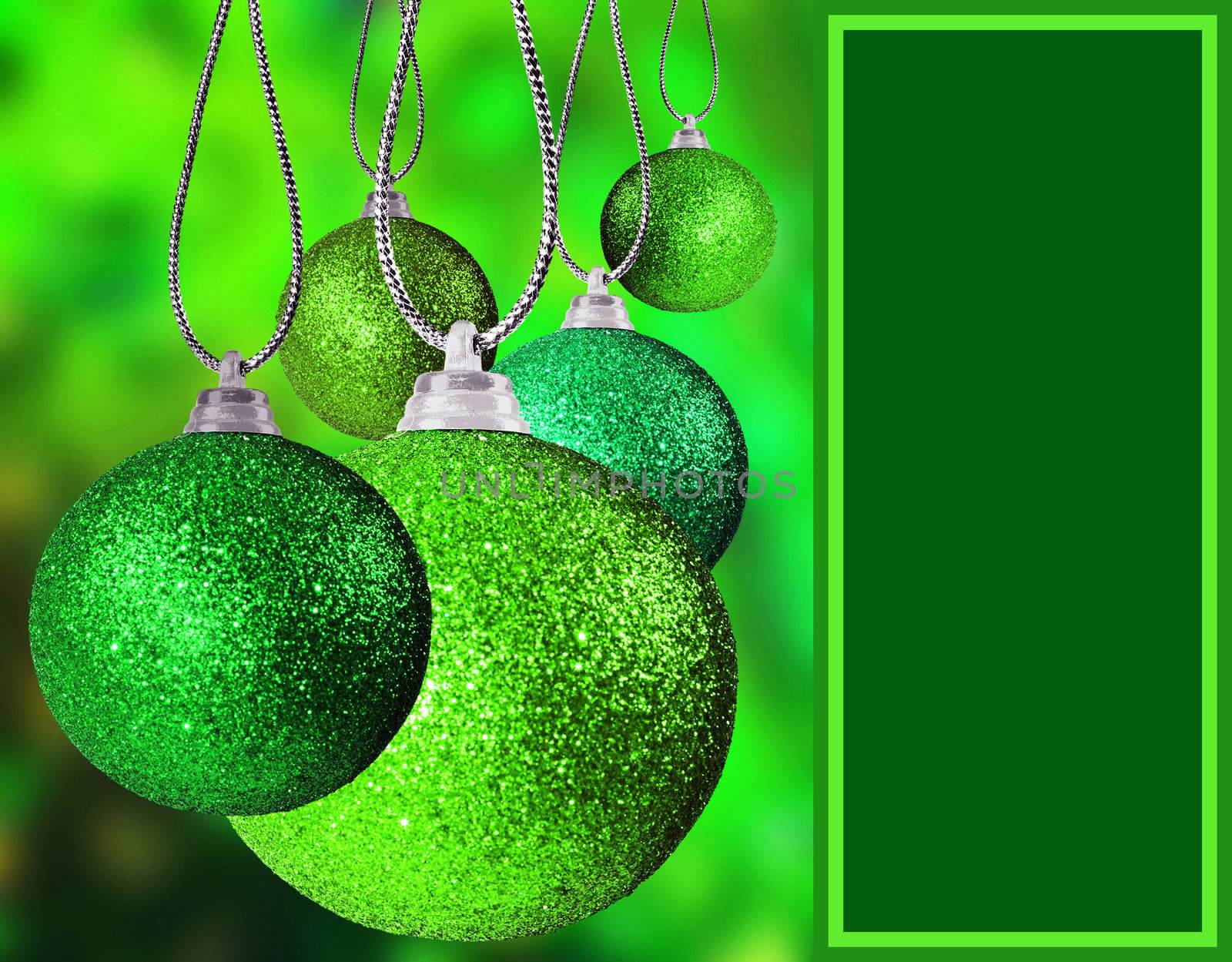 Close up of green christmas baulble balls in different sizes  hanging on strings