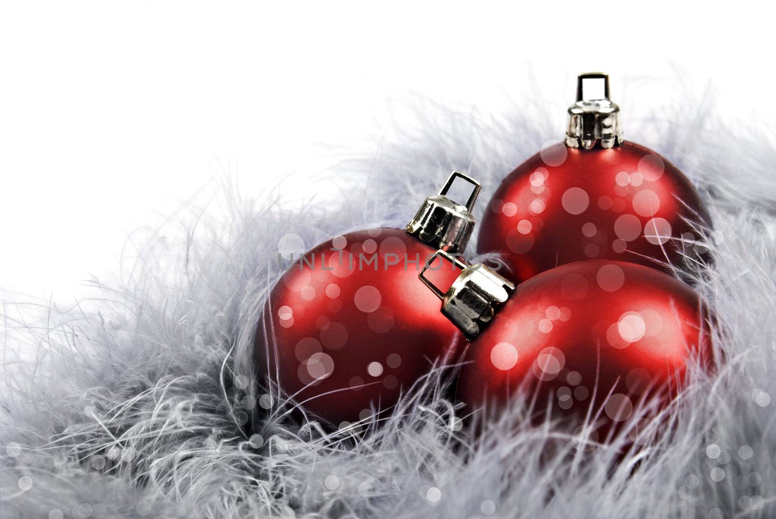 Red christmas baubles on a white background with space for text
