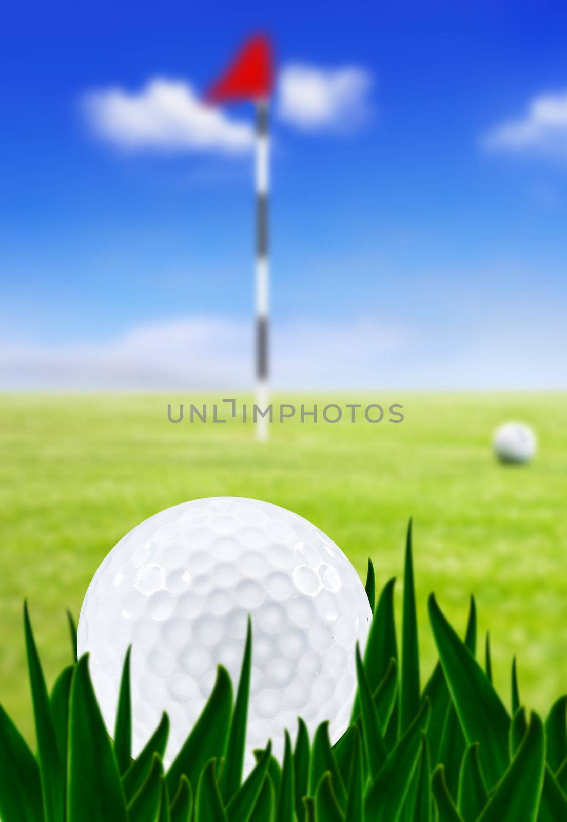 Golf ball on a golf course with the green in the background - very shallow depth of field