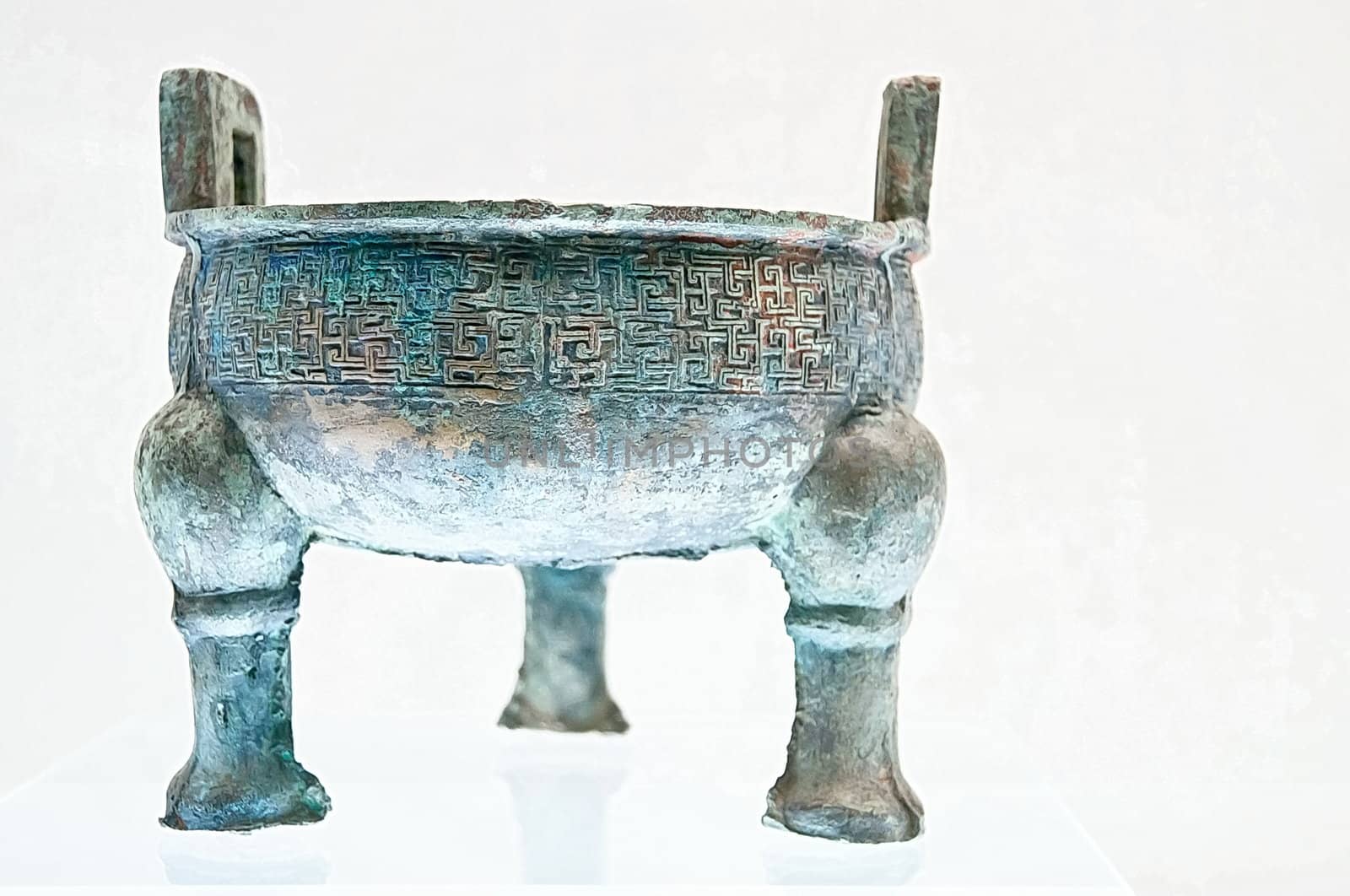 Ancient bronze chinese ding with legs, cooking vessel, isolated on white background