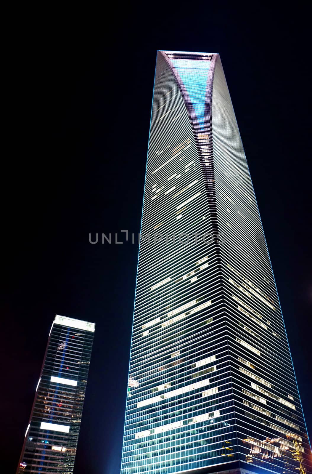 Vertical illuminated skyscraper at night in Shanghai Pudong district