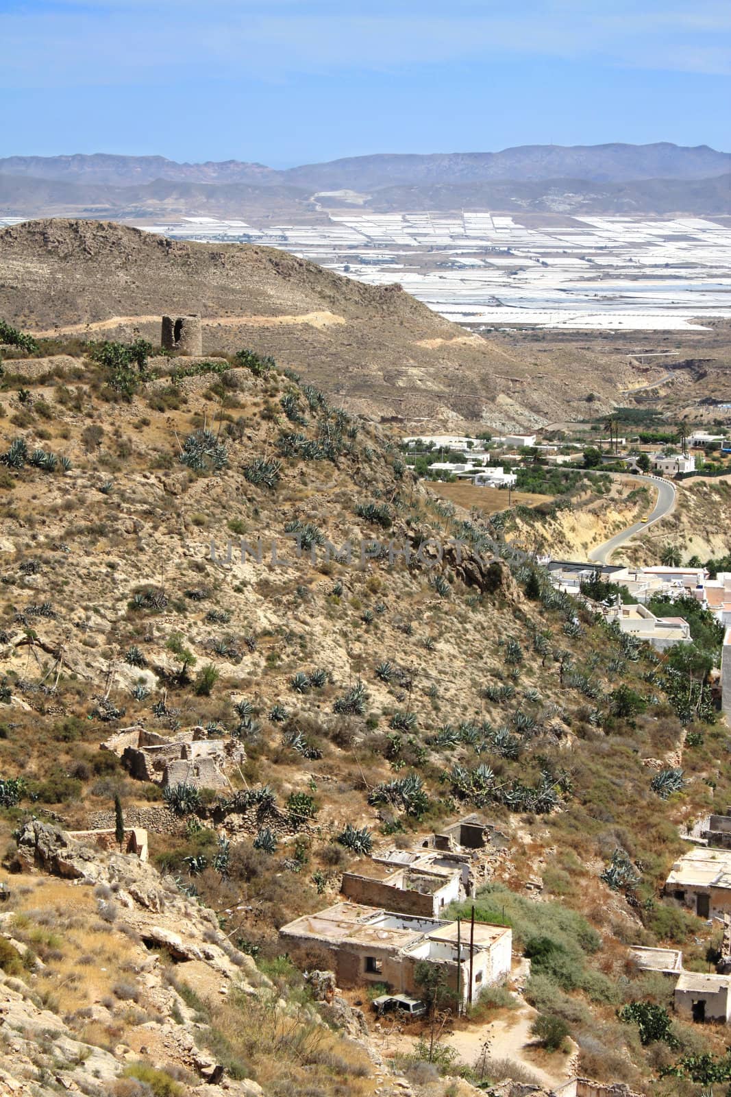 Arid landscape in Nijar, with greenhouses in the background. Province of Almeria, Andalusia, Spain.