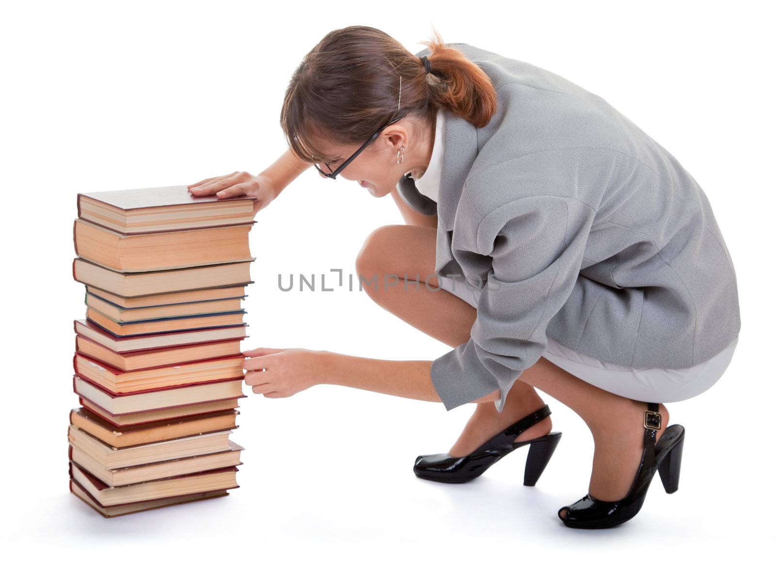 business woman  in spectacles and a pile of books