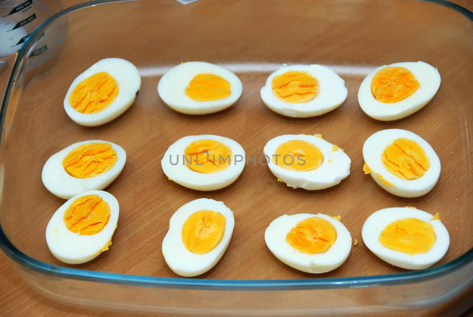 cut boiled eggs in glass dish in kitchen