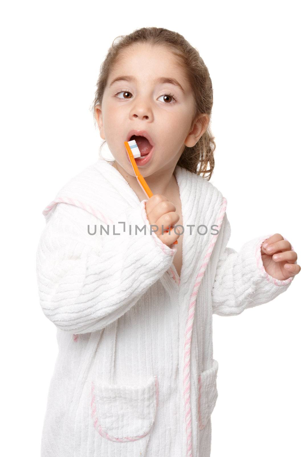 Young preschool age girl using a toothbrush to clean her teeth.
