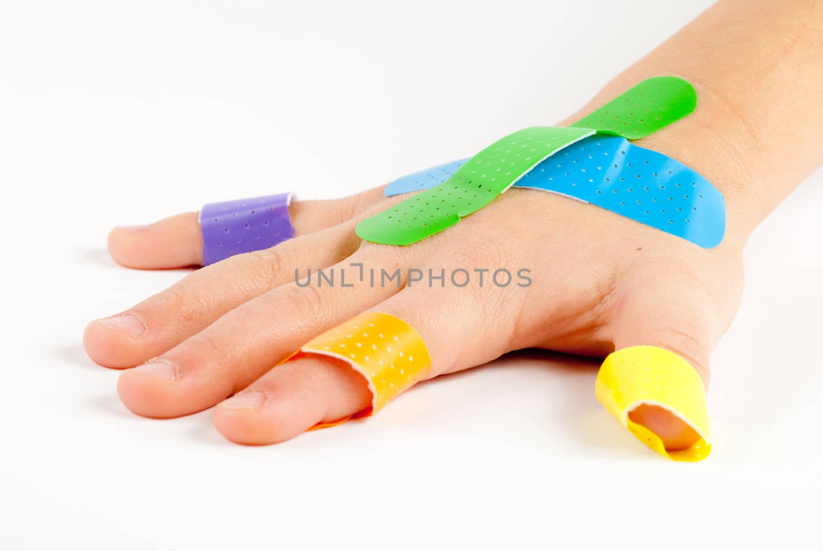 Colorful bandages on child's hand.