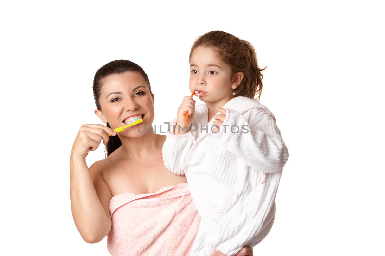 A mother and daughter brushing teeth using toothbrushes and aqua coloured mint flavoured toothpaste.  