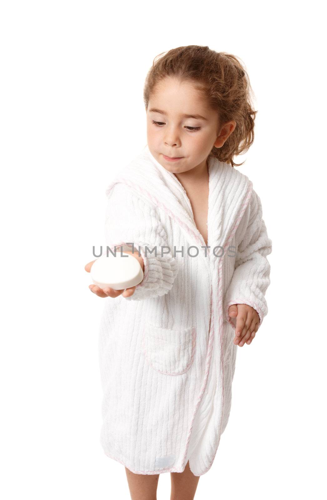 Beautiful young girl holding a bar of soap in the palm of her hand.