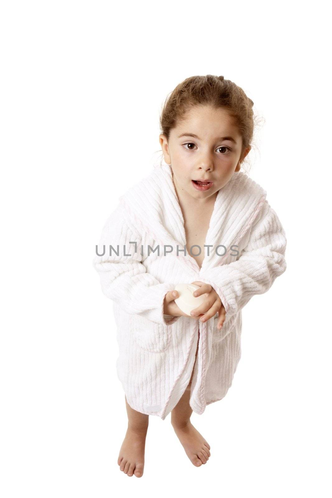 Little girl in bathrobe holding soap