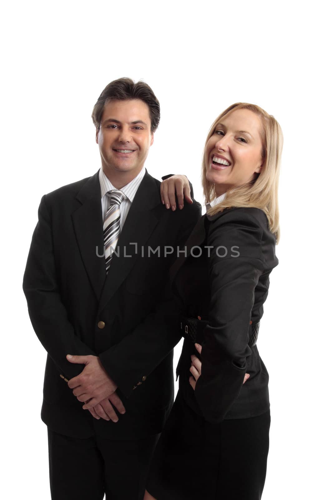 Successful  business partners, sales team or office colleagues confidently smiling or celebrate success or goal.  Could also be husband wife team.