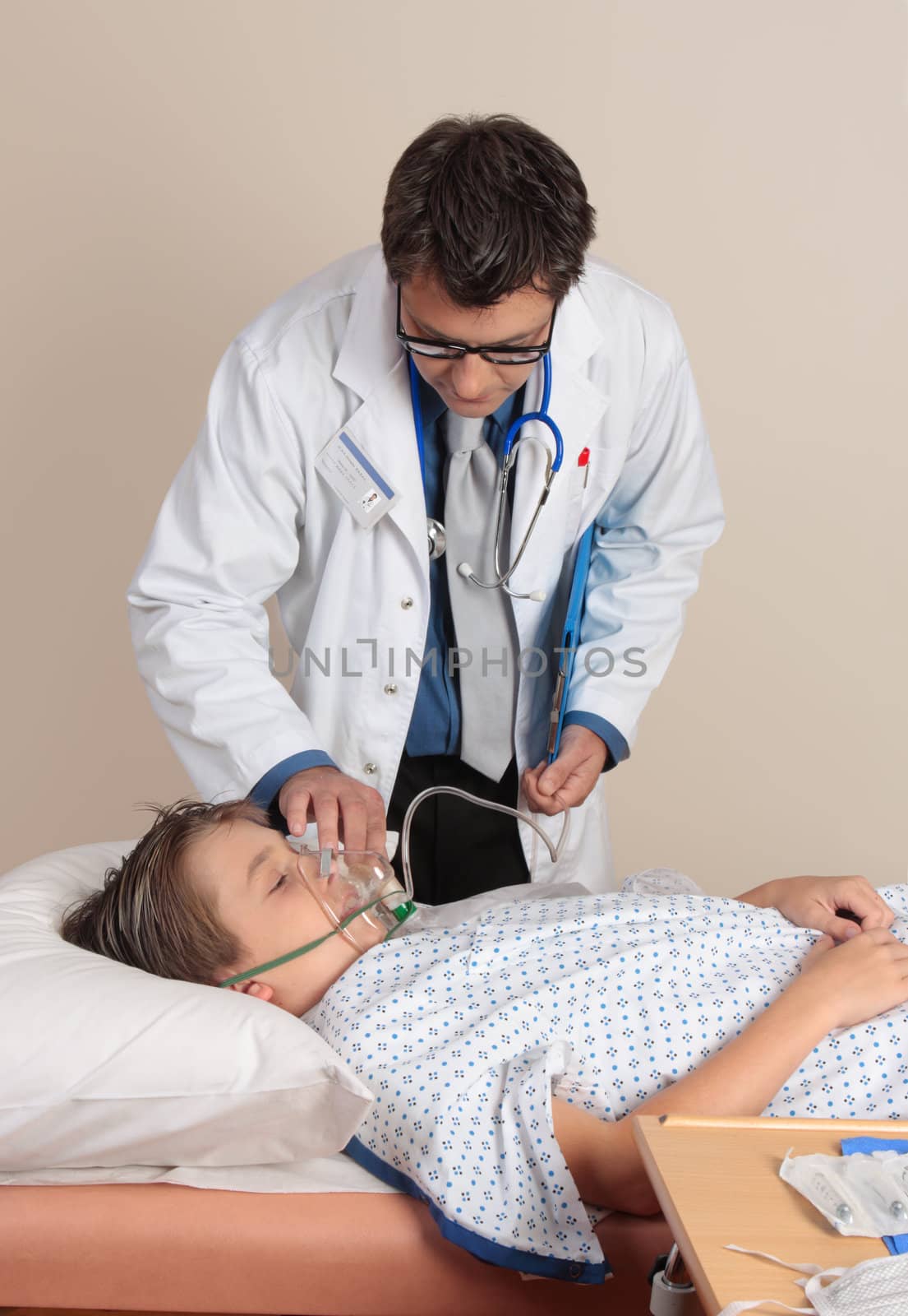 Doctor treating a patient, adjusting a face mask