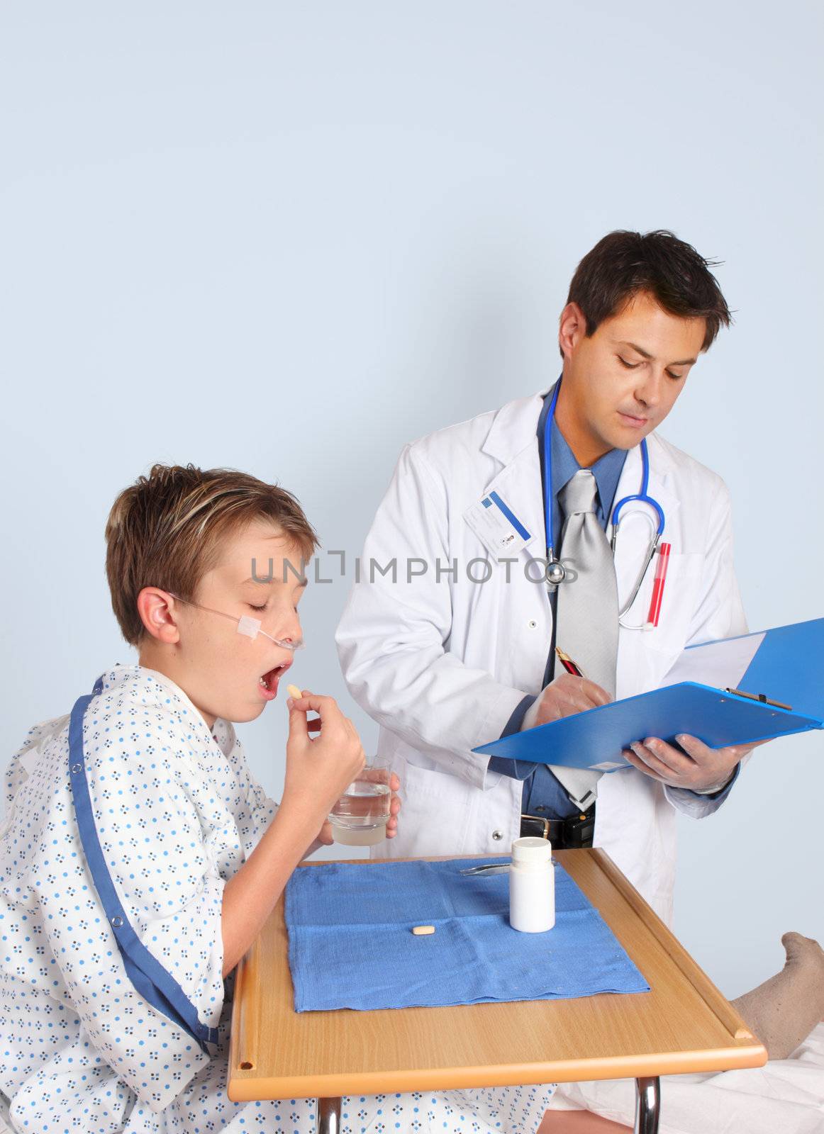 A doctor gives a young patient some medication and updates the patient medical record. No extra release required for ID badge.