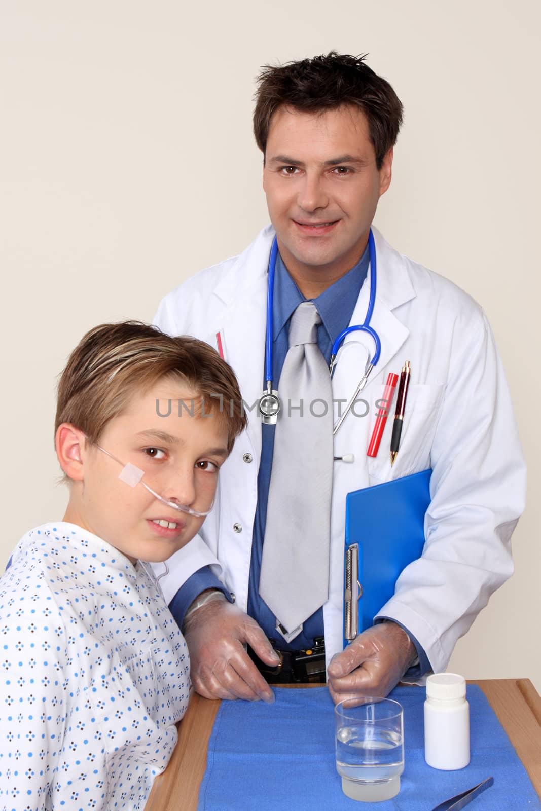 A doctor stands beside a young patient