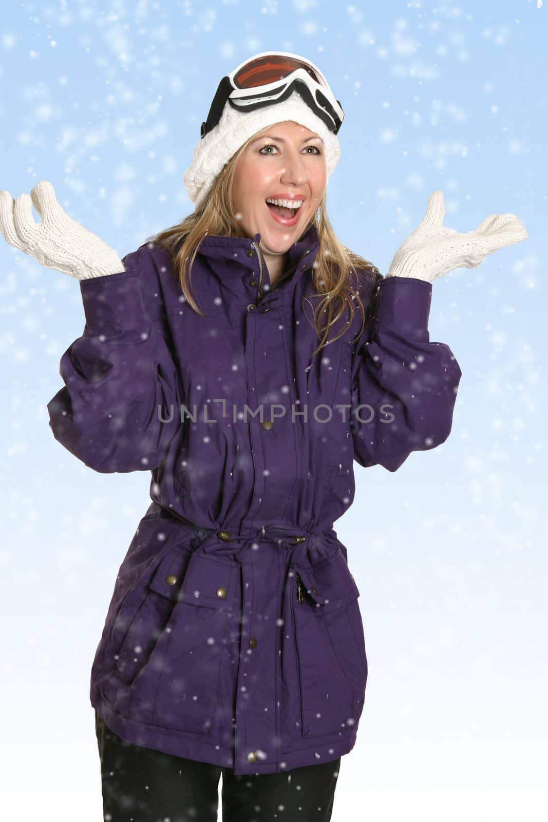 Happy woman enjoys the fresh snowfall